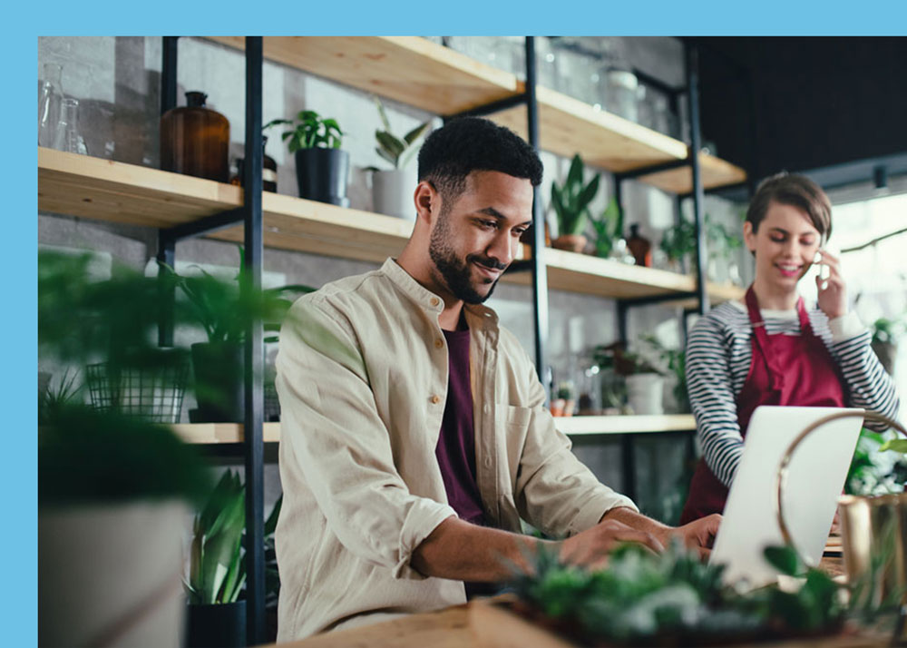 Business Owner signing up for insurance for his employees, shaking hands with insurance agent. Florida Health Connector - An Authorized Agency for Florida Blue - Insurance for Everyone in Florida